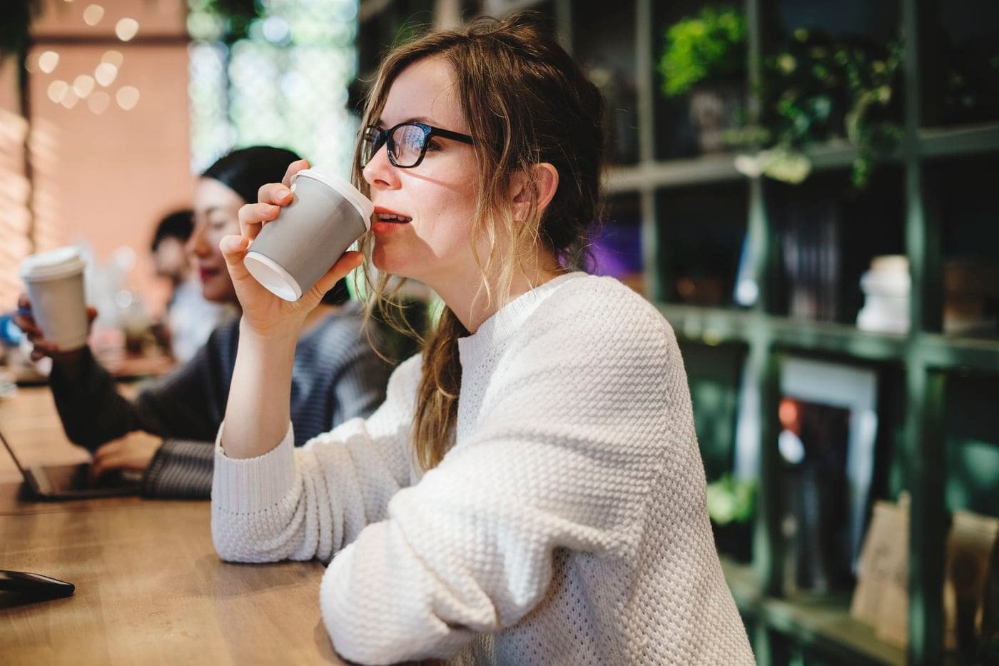 blond woman having a cup of coffee