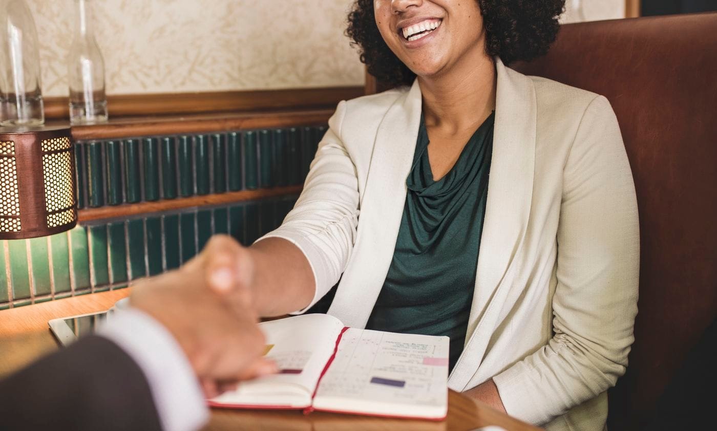 woman shaking hands with business partner